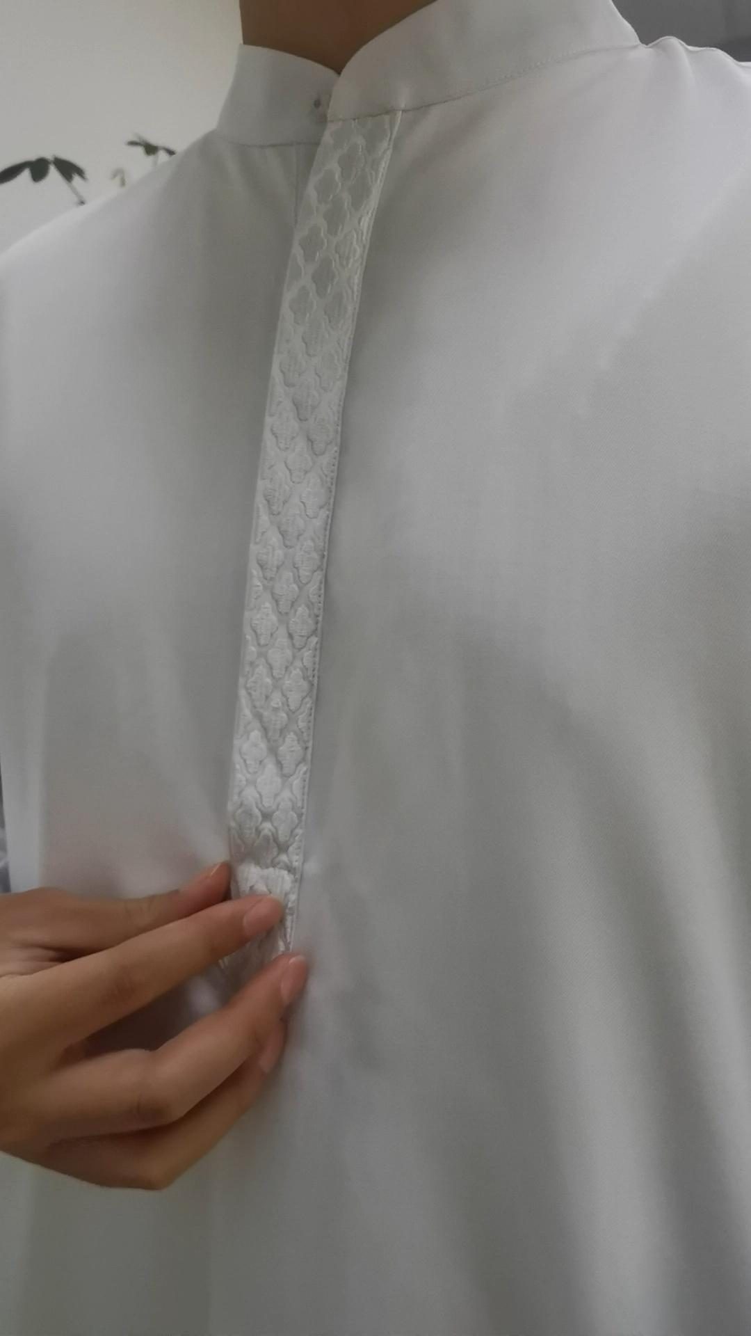 Elegant white thobe with raised geometric embroidery on chest placket